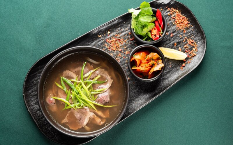Бульон с говядиной, рисовой лапшой и зеленью