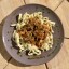 Кусочки говядины в пряном соусе с оливками с домашней лапшой